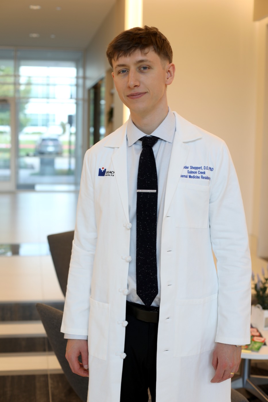 Dr. Alex Sheppert in a white coat at the clinic